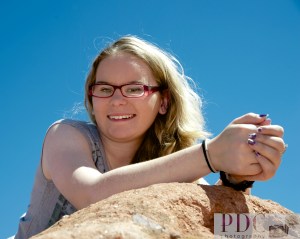 Libby laying on top of a rock at Garden of the Gods